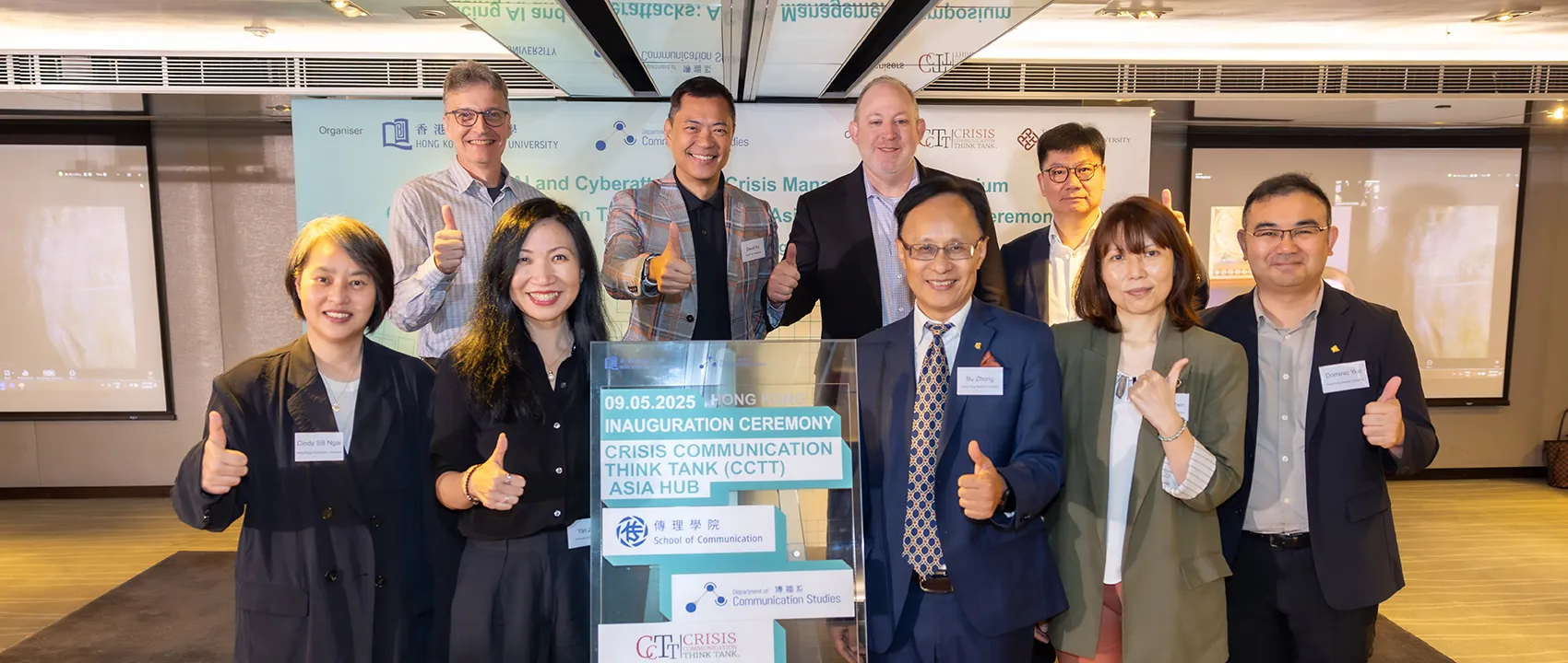 Group of people give a thumbs up.